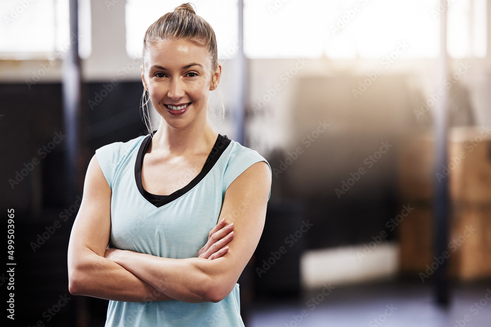 Wall mural Sign up today. Shot of a fit young woman at the gym for a workout.