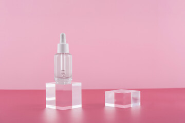 Serum cosmetic bottle with peptides and retinol on acrylic blocks on pink background. Cosmetics transparent product packaging with stylish props. Serum dropper mockup on pedestal podium, front view - obrazy, fototapety, plakaty