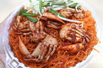 Fried noodle with crabs in Chanthaburi province style (Pad Thai in Thai language). One of the popular seafoods menu in street foods of Thailand.  