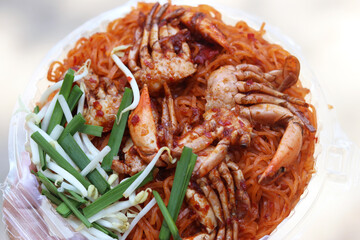 Fried noodle with crabs in Chanthaburi province style (Pad Thai in Thai language). One of the popular seafoods menu in street foods of Thailand. 