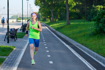 Running Woman on racetrack during training session. Female runner practicing on athletics race track