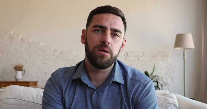 Serious bearded male employee applicant on vacant place introduce himself to hr pass job interview by video call. Webcam portrait young businessman look at camera negotiate with client in videochat