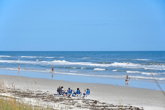 Tourists and locals enjoying a day at the beach in St Augustine Beach in Florida