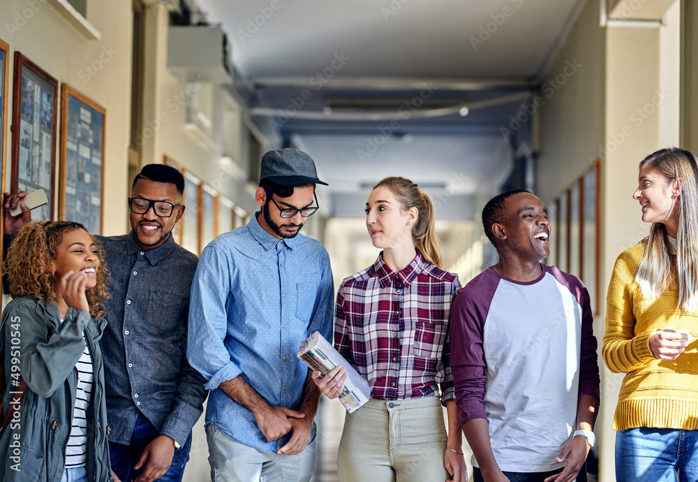 Poster Catching up after class. Cropped shot of a group of young university students walking through the campus halls.