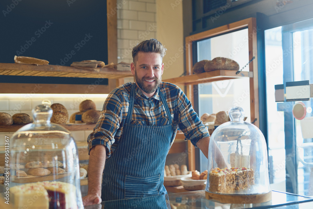Poster It doesnt get fresher than this. Portrait of a young business owner standing behind the counter in his bakery.