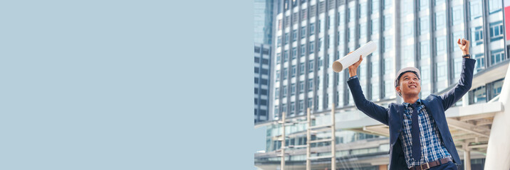Banner Victory businessman engineer power holding fist bump blueprint winner positive energy. Panorama Backside architecture man empowers in success city. Wide Businessman engineering with copy space