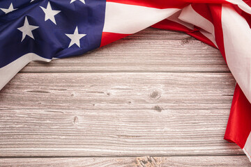 Top view of the American flag on a wooden table with copy space for text