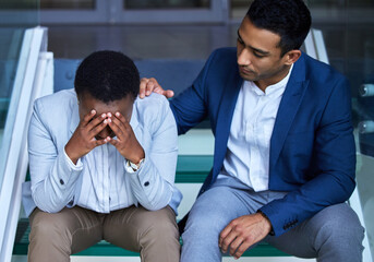 Be strong when everything seems to be going wrong. Shot of a young man comforting his colleague at...