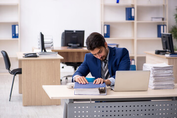 Young male employee working in the office