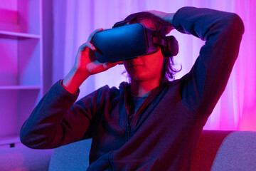 Man wearing virtual reality glasses is playing a 3D game with excitement, Bluetooth Remote...