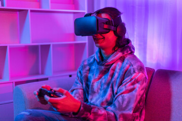 Man wears virtual reality glasses and uses joystick to play games with fun, Male in glasses of virtual reality, VR, Future games, Gadgets, Technology, Red and blue background, VR game concept.