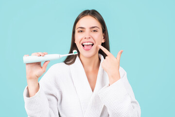 Closeup on happy young woman brushing teeth. White tooth.