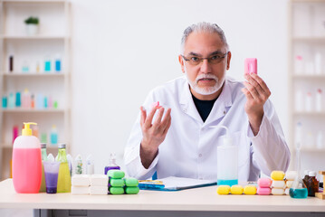 Old male chemist testing soap in the lab