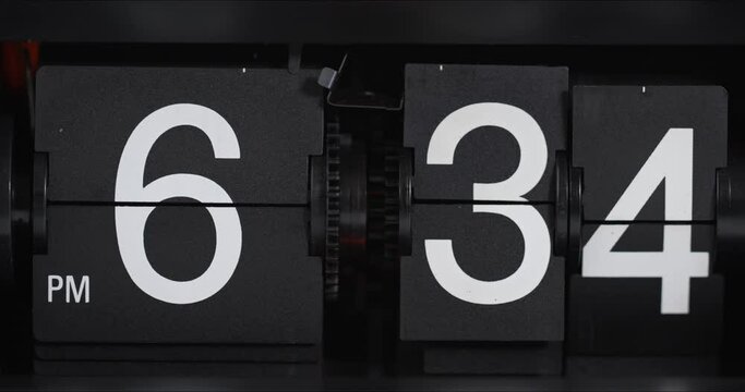 Classic flip clock on black background Showtime pm 06.34, Time concept.