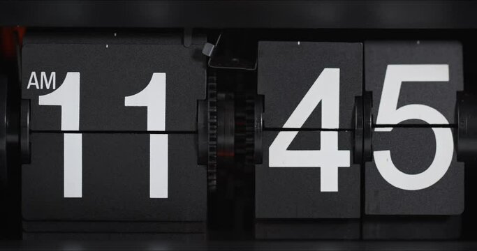 Time-lapse moving fast, flip clock on black background Showtime am 11.35 to pm 12.00, Time concept.