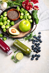 Assorted detox smoothie juices on light background.