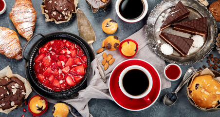 Dessert table with all kinds of cakes and snacks.