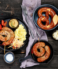 Grilled German sausages on wooden background.