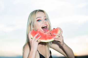 Closeup portrait of young blonde sensual woman eating watermelon. Tropical vacation travel sexy girl concept.