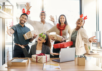 Sharing the Christmas spirit. Shot of a group of businesspeople celebrating during a Christmas party at work.