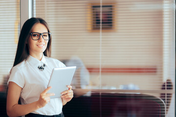 Businesswoman Standing in Front of Managerial Office Holding a Tablet
