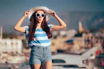  Surprised Female Tourist Wearing a Sun Hat and Sunglasses © nicoletaionescu