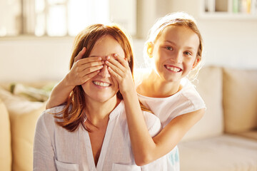 Youre going to love this. Shot of an adorable little girl bonding with her mother at home and...