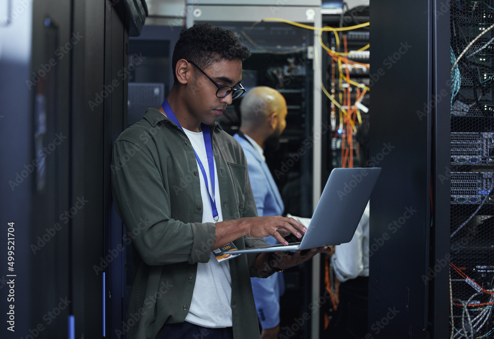 Fototapete IT work in progress. Cropped shot of two male IT support agents working together in a dark network server room.