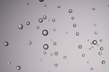 Drops of water on a transparent gray background.