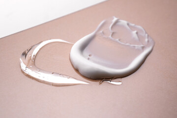 Serum and cream on a beige background. Textures.