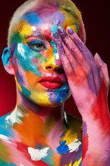 Theres a reason we dont see the world in black and white. Studio shot of a young woman posing with multi-coloured paint on her face.