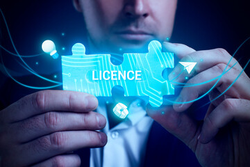 Obraz premium Business, Technology, Internet and network concept. Young businessman working on a virtual screen of the future and sees the inscription: Licence