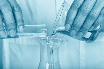Chemical reagent pouring and mixing, Laboratory and science experiments, Formulating the chemical for medical research.
