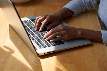 Manicured hands of woman typing on laptop