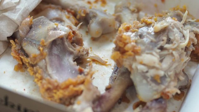Food waste concept. Bones of fried chicken in a restaurant