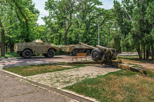 Exhibition of military equipment on the Alley of Military Glory in Peremohy Park in Mykolaiv, Ukraine. APC, BRDM and Howitzer in the city garden