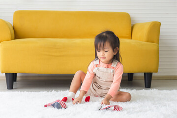 Little child girl with USA flag playing on floor, Kid girl with the American flag in living room