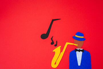 International Jazz Day. Silhouette of a musician with a saxophone from which melodies flew out, on...