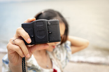 Hand of woman holding the vintage camera. ,Vintage Film camera in girl's hands close up