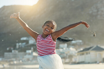 Summers finally here. Portrait of an adorable little girl having fun at the beach.