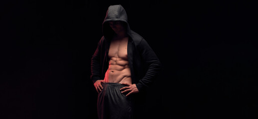 Fototapeta na wymiar Handsome strong man with strong abs and sexy torso on dark isolate background. Muscles workout fitness and bodybuilding concept