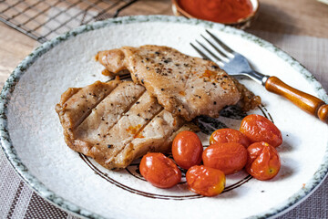 Grilled pork steak with tomatoes.Top view