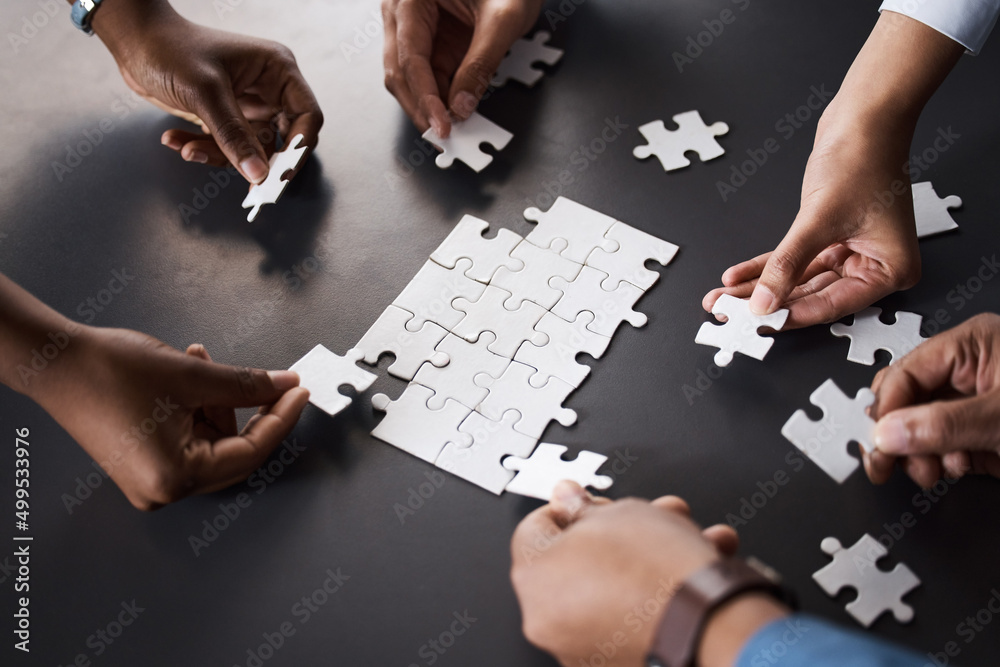 Poster Problem solving as a dedicated team should. Closeup shot of a group of unrecognisable businesspeople joining puzzle pieces together in an office.