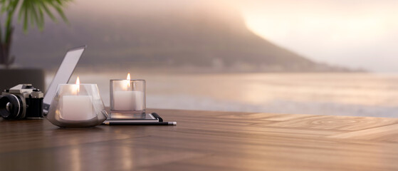 Wood table with copy space and romantic candle lights against blurred sunset view