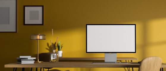 Modern stylish creative workspace with desktop computer against yellow wall