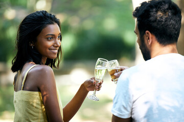 Love is something that should be celebrated. Shot of a young couple making a toast while out on a date.