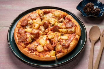 Top view of hot Mushroom and Sausage Pizza on wooden background.