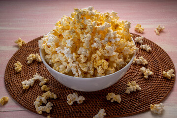 Popcorn in bown on wooden background. Popcorn in bowl on wooden table.