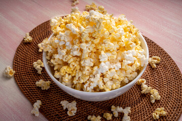 Popcorn in bown on wooden background. Popcorn in bowl on wooden table.
