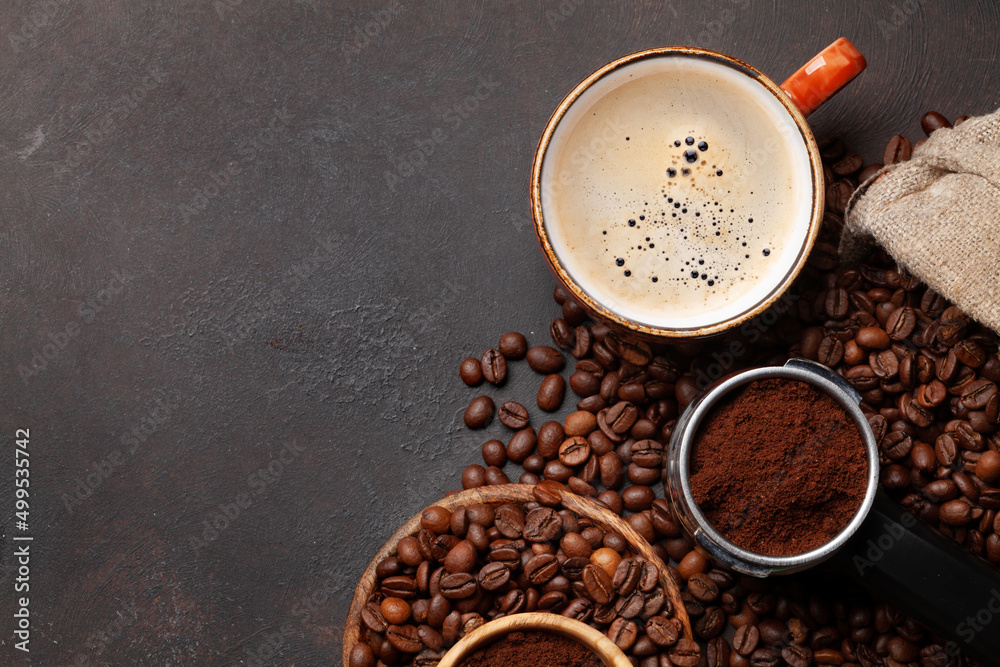 Wall mural Roasted coffee beans and ground coffee in filter holder